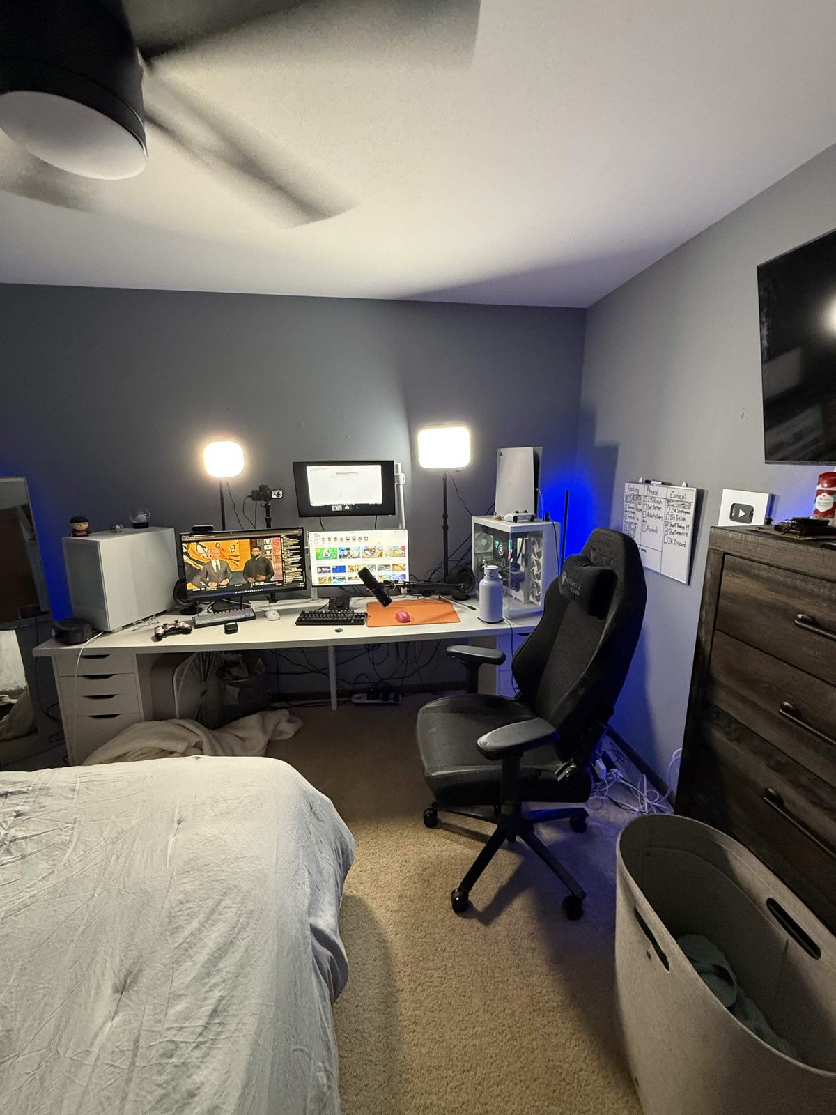 Content creation workspace with desk, monitors, lighting, and creator award